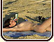 Female nudist taking sun bath