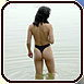 A girl in monokini standing in the water