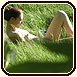 Hidden cam picture of a nudist babe sunbathing on the grass